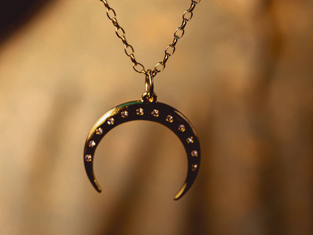 Gold necklaces with a blue gemstone pendant