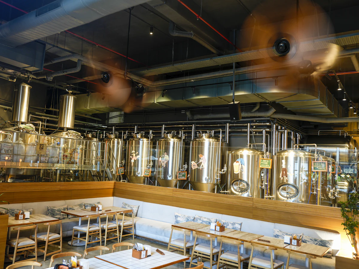 A brewery taproom with tanks behind the bar