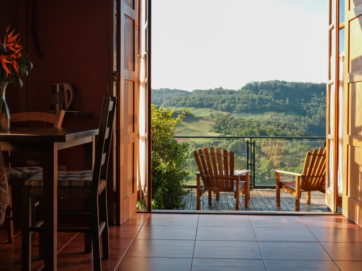 Chairs on a balcony overlooking green hills